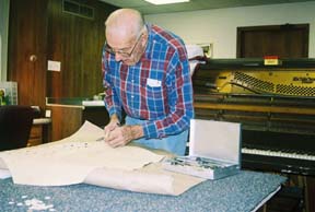 Roy Schmidt restores a player piano. [Photo by Tom Ineck]