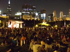 Chicago's skyline glows as a crowd gathers at Grant Park for an evening performance. [Photo by Tom Ineck]